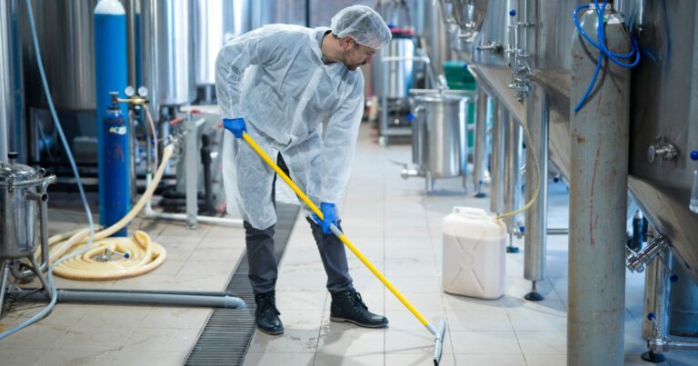 Industrial cleaning team removing chemical residues